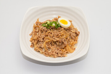 A Thai basil minced pork set meal arranged on a tray, including a portion of stir-fried spicy basil pork, a bowl of steamed white rice, three side vegetables, and a bowl of soup. The presentation refl