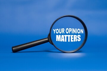 YOUR OPINION MATTERS written on a magnifying glass. Blue background. Business concept.