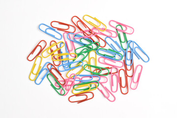 Pile of colorful paper clips isolated on white background