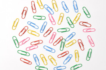 Colorful paper clips isolated on white background, flat lay, top view