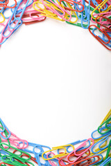 Colorful paper clips frame a white background, creating a vibrant, playful border. Ideal for office, school, or creative design with copy space in the center.