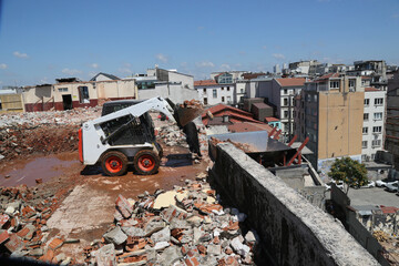 skid steer loader working construction site. mini loader transports excavation waste at...
