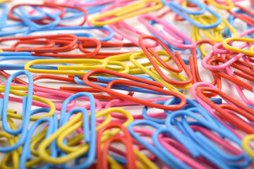 Pile of colorful paper clips on white background