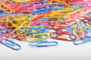 Many colorful paper clips isolated on white background