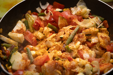 Preparing a healthy, balanced meal: frying frozen vegetables and chicken in a pan. Nutritious cooking, clean eating, and wholesome diet concept for a healthy lifestyle