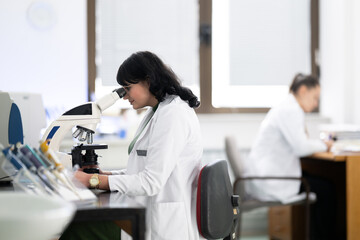 Doctor scientist using microscope in laboratory
