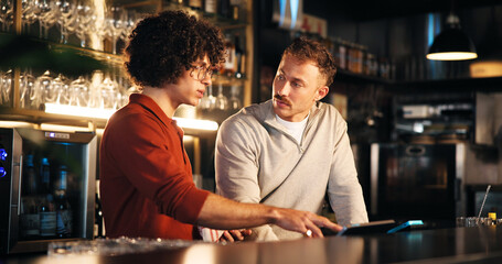 Bar, manager and training with tech for order, teamwork and explaining system to employee and...