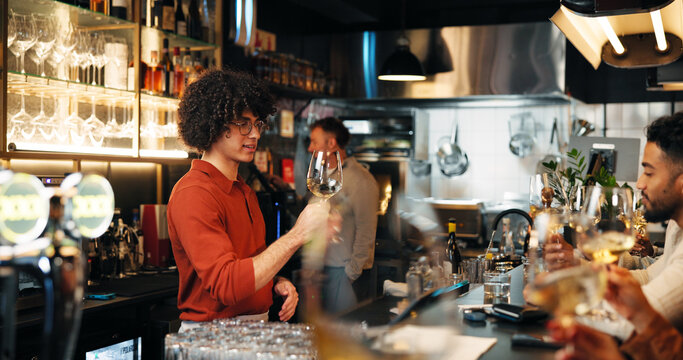 Wine tasting, alcohol and man with glass in restaurant for customer service, order and hospitality. Nightclub, pub and bartender with drinks, beverage and liquid for serving people in happy hour - Powered by Adobe