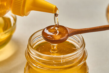 honey dripping from a wooden spoon