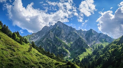A majestic mountain range with lush green slopes and rocky peaks under a clear blue sky with scattered clouds.
