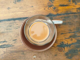 cup of coffee latte on wooden table. Top view perspective 