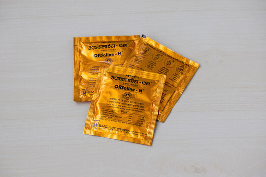 SMC Orsaline-N sachets on a wooden surface. Bangladesh's top trusted brand for diarrhea and dehydration management, ORSaline-N is available everywhere, providing essential rehydration support.