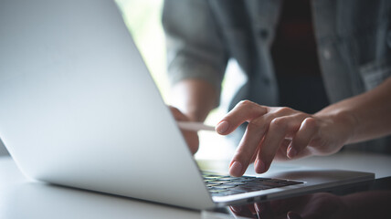 Close up, Business woman working on laptop computer with digital tablet on office table. Woman...