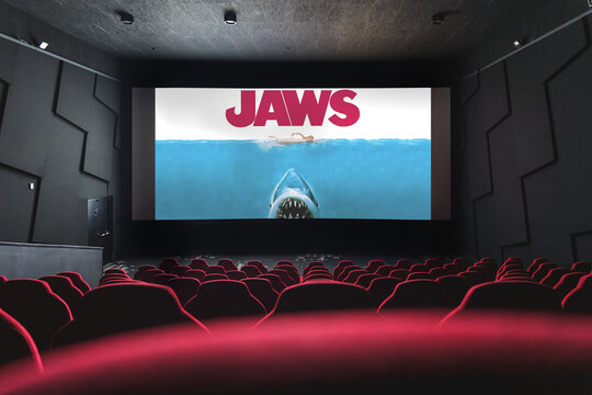 Jaws movie showing in empty cinema, classic shark thriller playing on big screen.