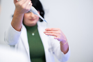 Scientist using pipette in laboratory experiment