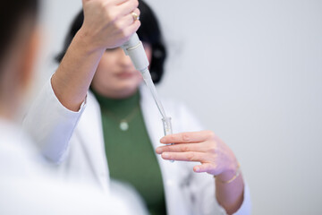 Scientist using pipette in laboratory experiment
