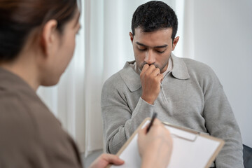 man with mental health problems is consulting. psychiatrist is recording the patient's condition...