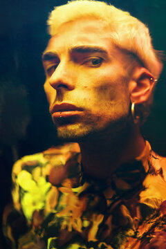 Distorted reflection of a young guy on dichroic film