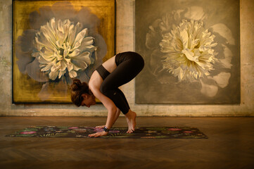 Young woman practicing yoga poses in an art gallery space, combining wellness and creativity. Mindful lifestyle, body awareness, and harmony in modern cultural environment