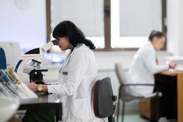 Doctor scientist using microscope in laboratory
