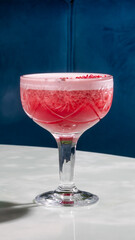 Chilled cranberry fizz in delicate crystal, embodies Yuletide mirth and Bubble Bath Day extravagance, effervescent crimson delight