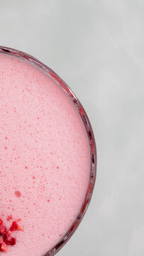 Frothy pink elixir whispers of summer solstice celebrations, invoking strawberry moon rituals and whimsical berry fizz daydreams