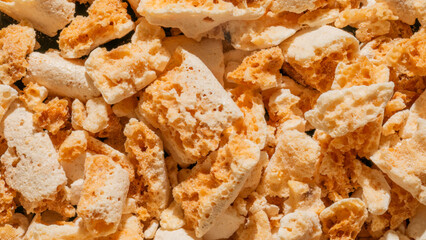 Golden honeycomb candy shards resemble textural terrains, crunching sweet symphony for Diwali...