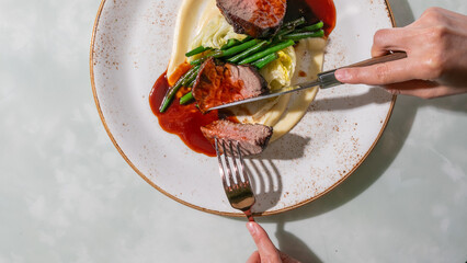 Sizzling filet mignon symphony with zesty red sauce, embodying culinary opulence for Gourmand's...
