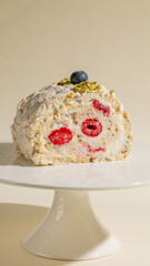 Whimsical pavlova roll adorned with vibrant raspberries, celebrating Pi Day and National Pistachio Day with a taste of elegance