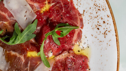 Succulent beef carpaccio draped with arugula whispers gourmet indulgence, perfect for La Tomatina or a midsummer night feast