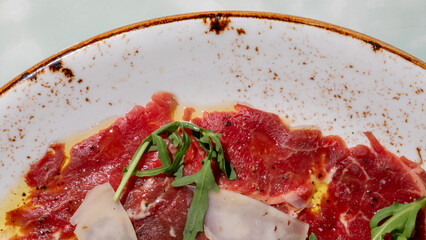 Sliced carpaccio glistens with olive oil, reminiscent of Italian Ferragosto feasts, with rustic...