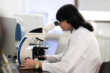 Doctor scientist using microscope in laboratory