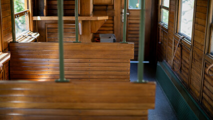 Vintage wooden tram interior whispers nostalgia, echoing past journeys, evoking Steampunk Revival...