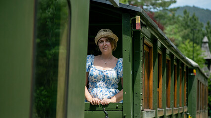 Ethereal journey on vintage train, contemplative Caucasian woman in serene summer, uncovering...
