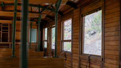 Wooden train car interior whispers nostalgic wanderlust, reminiscent of bygone era, ideal for Slow...