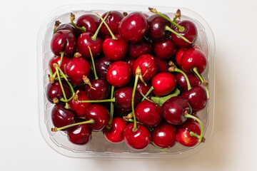 Succulent cherries glisten like rubies in vintage transparent tray, perfect for Hanami feasts and...