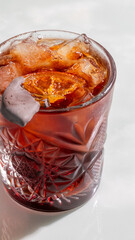 Crimson cocktail with a tangy citrus twist, shimmering with icy allure, perfect for Aperitif Hour...