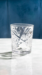 A crystalline glass sits poised against a velvet blue backdrop, perfect for Lunasa festivities or...