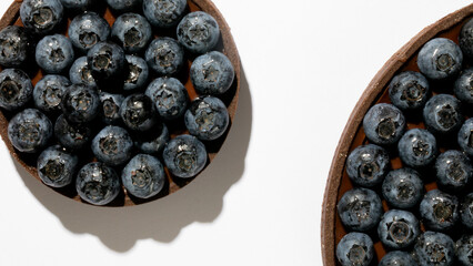 Juicy blueberries glisten under sunlight, evoking Midsummer Night's Feast, an edible treasure,...