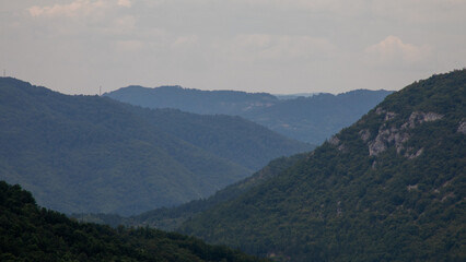 Misty mountain layers weave a tranquil tapestry, whispering secrets of midsummer night's eve and zen meditation escapes  Šarganska (sharganska) osmica