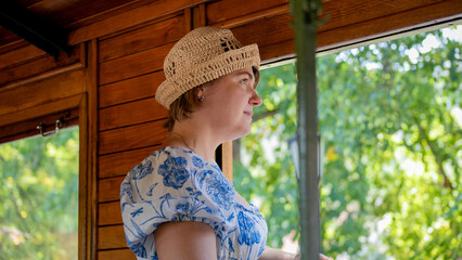 Vintage-inspired journey with a smiling Caucasian woman in a floral dress, mesmerized by golden hour's embrace; whimsically captured for National Train Day and World   Šarganska (shargaPhotography Day