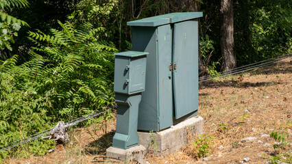 Aging electrical box basks in sunlit abandonment, a silent sentinel of forgotten technology, Earth...