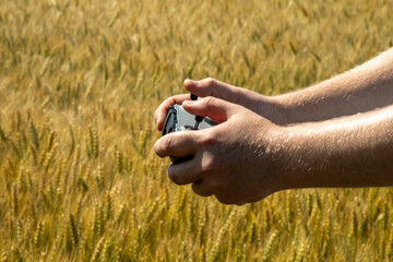 Navigating innovation amidst golden wheat, Caucasian male engages tech adventure, embracing...