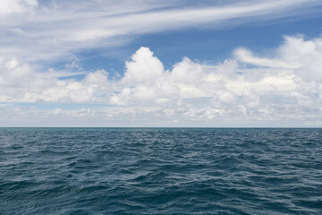 Ocean waves with turquoise water and white clouds