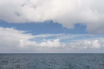 Ocean waves with turquoise water and white clouds