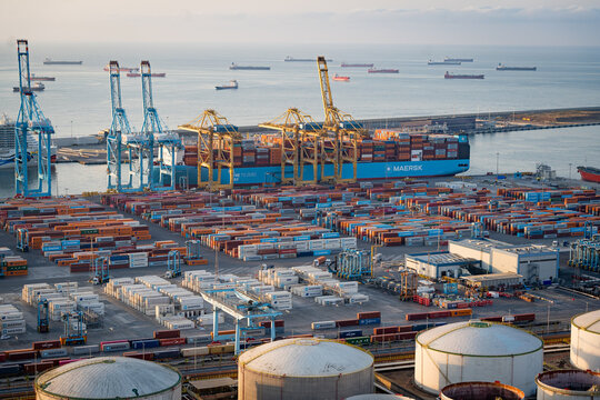 Barcelona, Spain - 18th July 2025: Shipping containers and cargo ships are seen in the port. Concept of trade war and maritime trade and tariffs