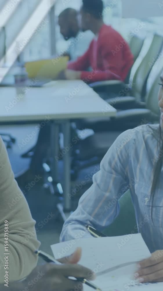 Poster animation of multiple graphs and globe over multiracial colleagues analyzing documents on desk