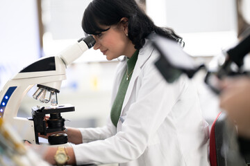 Doctor scientist using microscope in laboratory