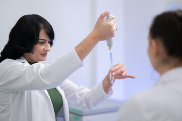 Two scientists holding test tubes with yellow liquid