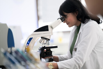 Doctor scientist using microscope in laboratory